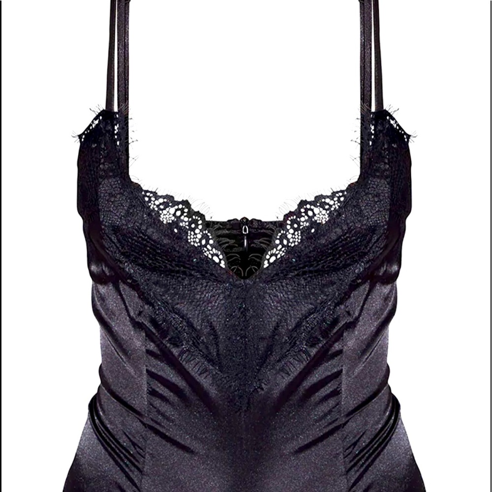 Featuring a satin black material with an eyelash lace trim and popper fastening.